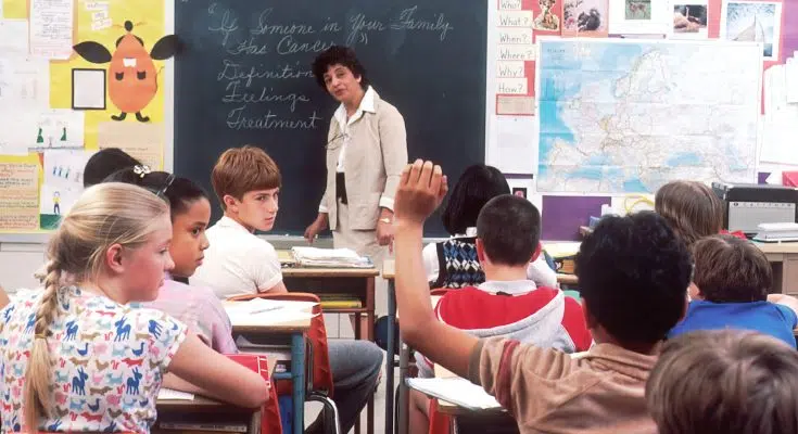 woman standing in front of children